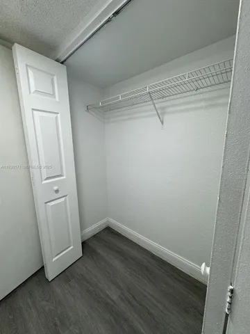 a view of a room with wooden floor and closet