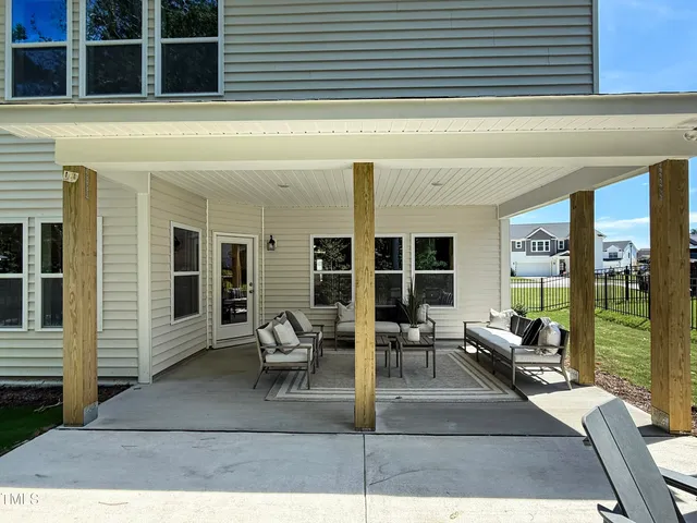 a view of a patio with couches chairs and potted plants