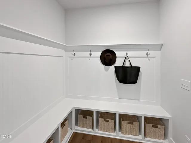 a view of a kitchen with a fridge and wooden floor