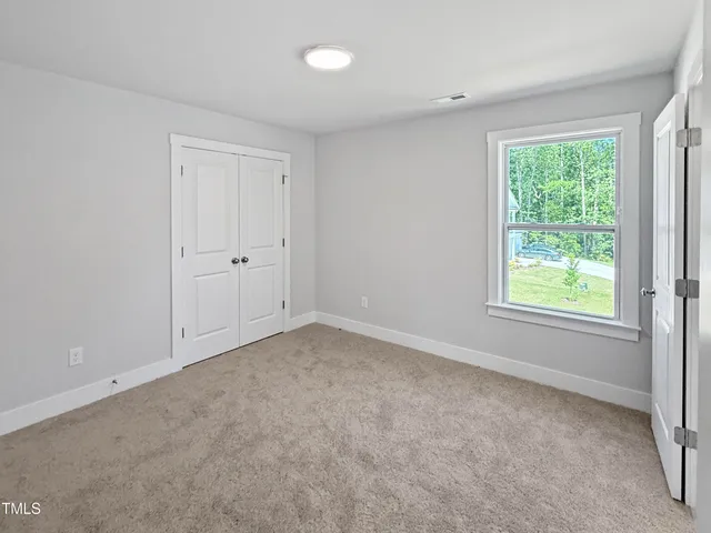 a bathroom with double vanity sink a mirror and a toilet