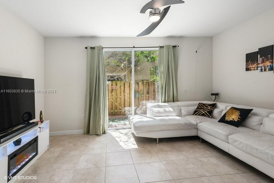 9165 Southwest 227th Street, Unit 5 Cutler Bay, FL 33190 - Photo 12 of 26 a living room with furniture and a flat screen tv