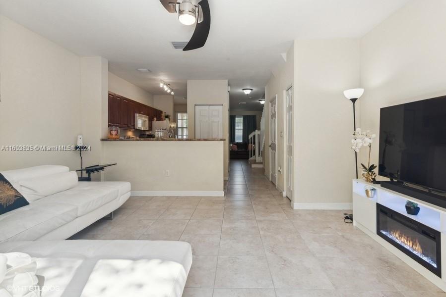 9165 Southwest 227th Street, Unit 5 Cutler Bay, FL 33190 - Photo 17 of 26 a living room with furniture and a flat screen tv