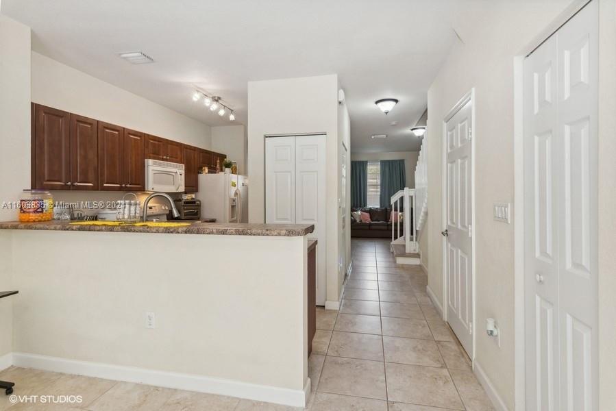 9165 Southwest 227th Street, Unit 5 Cutler Bay, FL 33190 - Photo 18 of 26 a view of a kitchen from the hallway