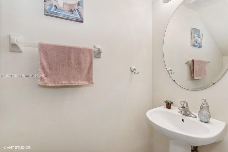 9165 Southwest 227th Street, Unit 5 Cutler Bay, FL 33190 - Photo 21 of 26 a bathroom with a sink and a mirror