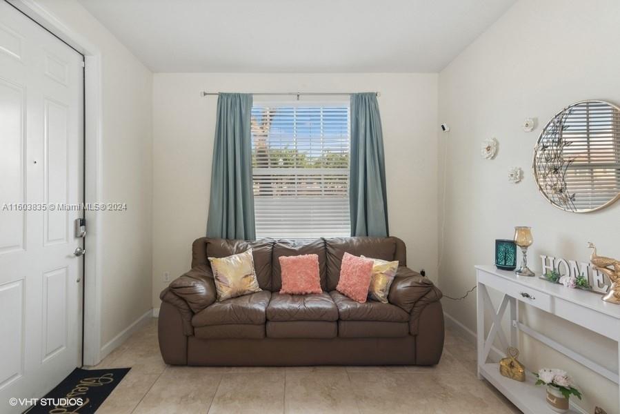 9165 Southwest 227th Street, Unit 5 Cutler Bay, FL 33190 - Photo 23 of 26 a living room with furniture and a window