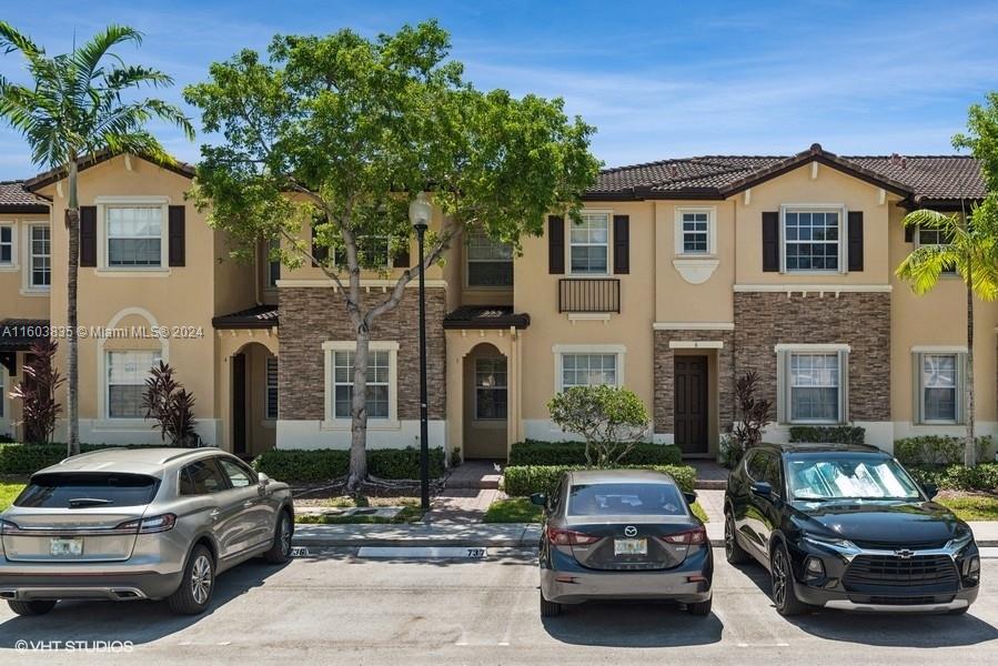 9165 Southwest 227th Street, Unit 5 Cutler Bay, FL 33190 - Photo 3 of 26 a car parked in front of a house