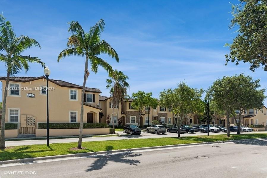 9165 Southwest 227th Street, Unit 5 Cutler Bay, FL 33190 - Photo 4 of 26 a front view of a building with tree s
