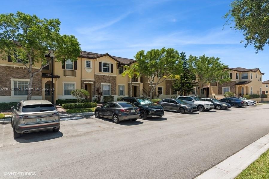 9165 Southwest 227th Street, Unit 5 Cutler Bay, FL 33190 - Photo 6 of 26 a view of a car parked in front of a house