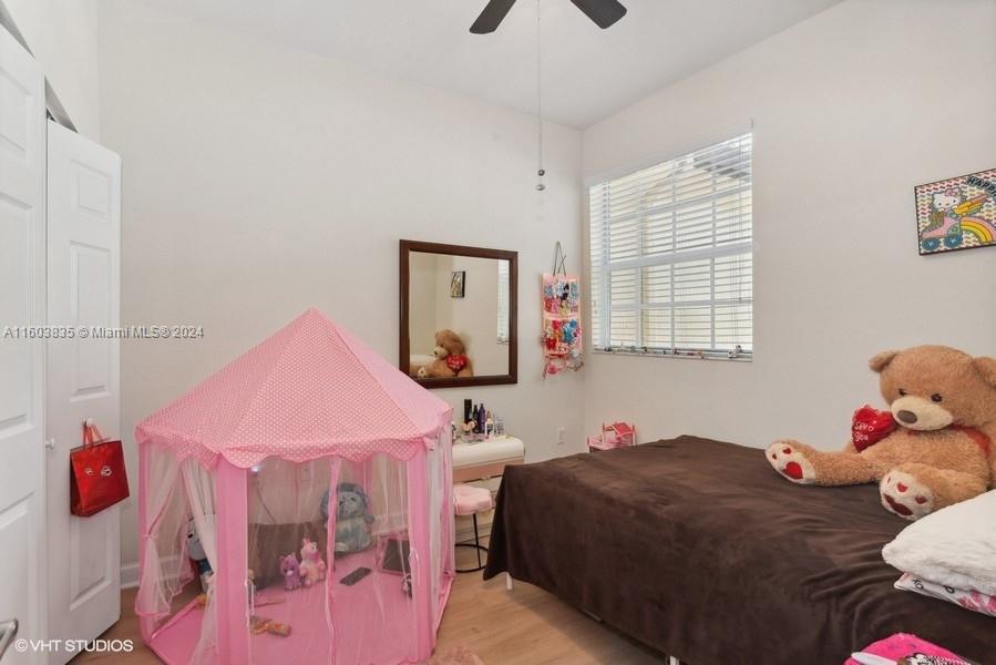 9165 Southwest 227th Street, Unit 5 Cutler Bay, FL 33190 - Photo 8 of 26 a bed room with a bed and a window