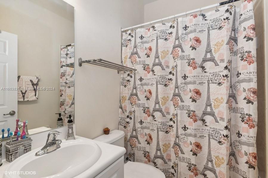 9165 Southwest 227th Street, Unit 5 Cutler Bay, FL 33190 - Photo 9 of 26 a bathroom with a sink toilet and shower