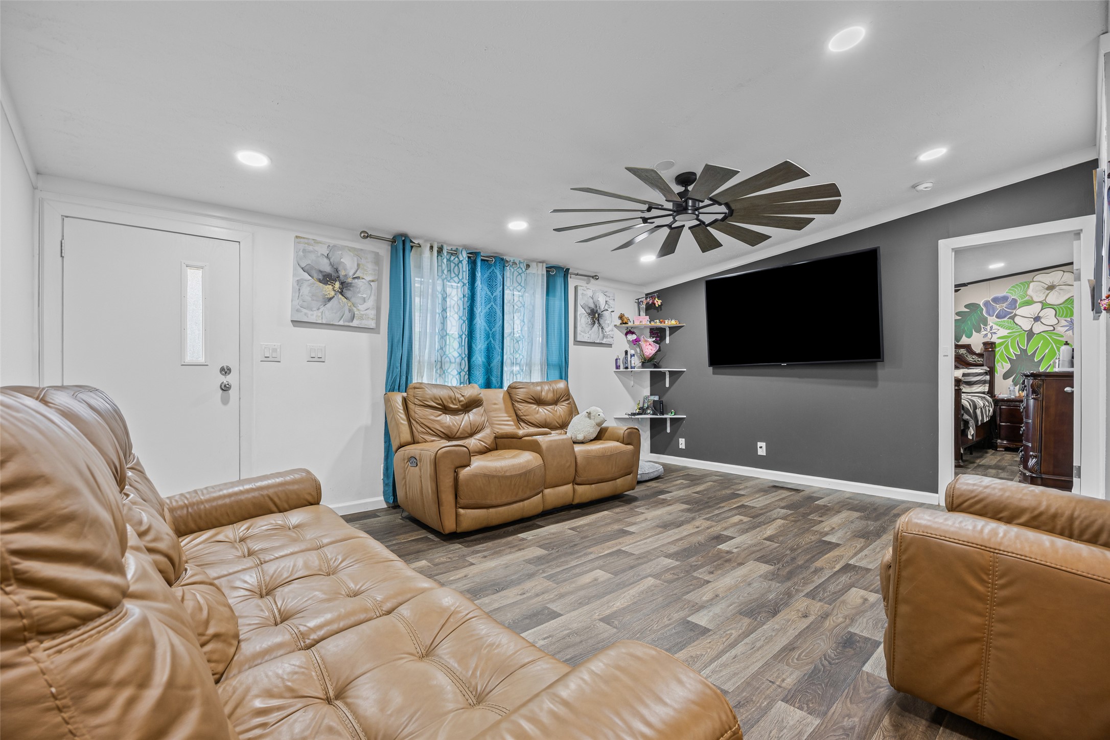 564 Boyd Road Red Rock, TX 78662 - Photo 22 of 25 A relaxed living area boasts recessed lighting and durable wood-look flooring.
