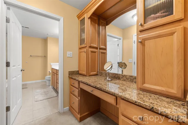 a bathroom with a double vanity sink toilet and a mirror