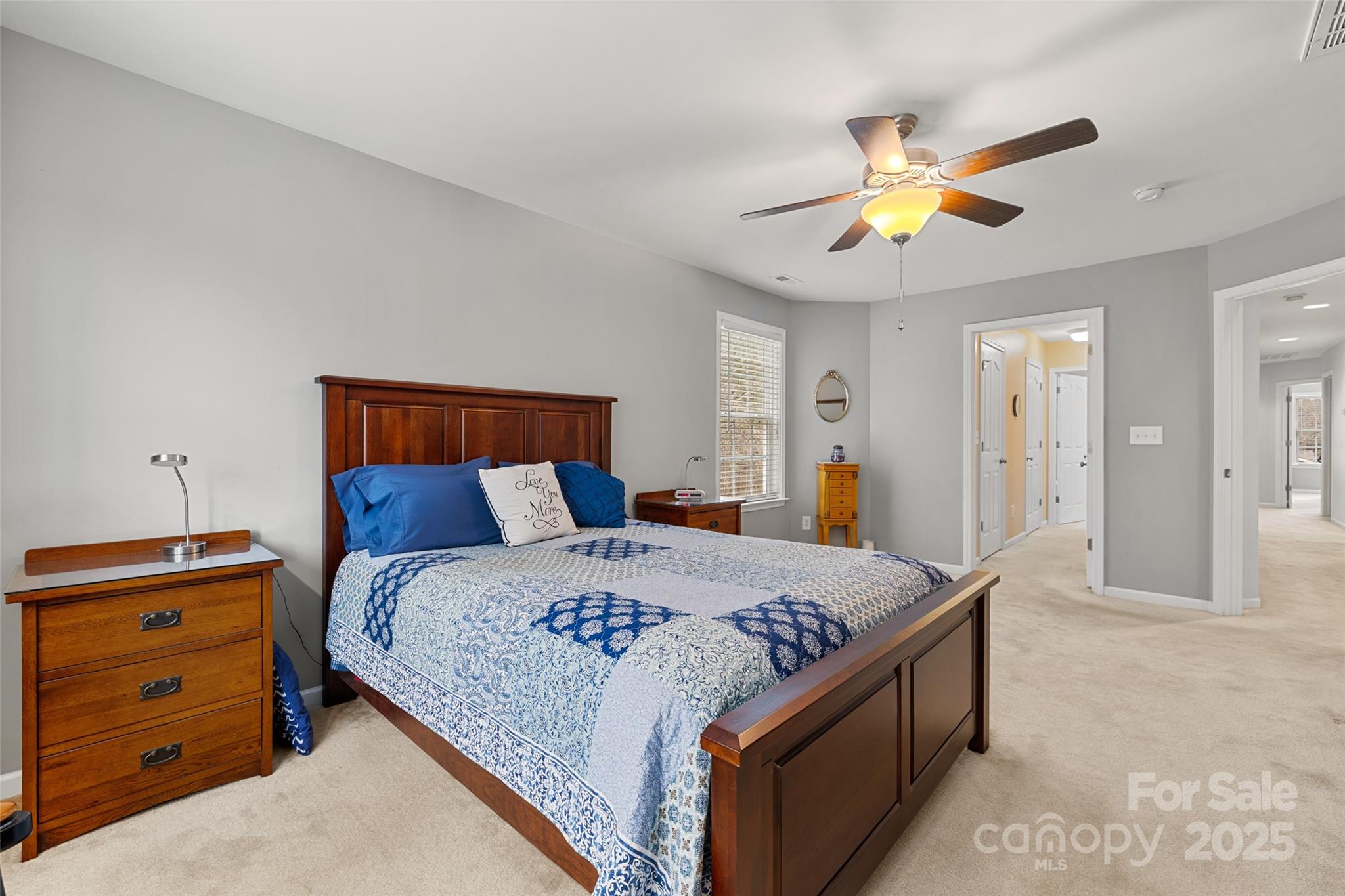 719 Deerbrook Lane Tega Cay, SC 29708 - Photo 13 of 33 a bedroom with a bed and a chandelier