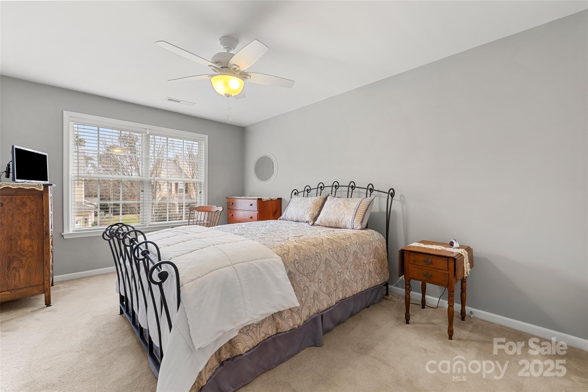 719 Deerbrook Lane Tega Cay, SC 29708 - Photo 17 of 33 a bedroom with a bed and a chandelier