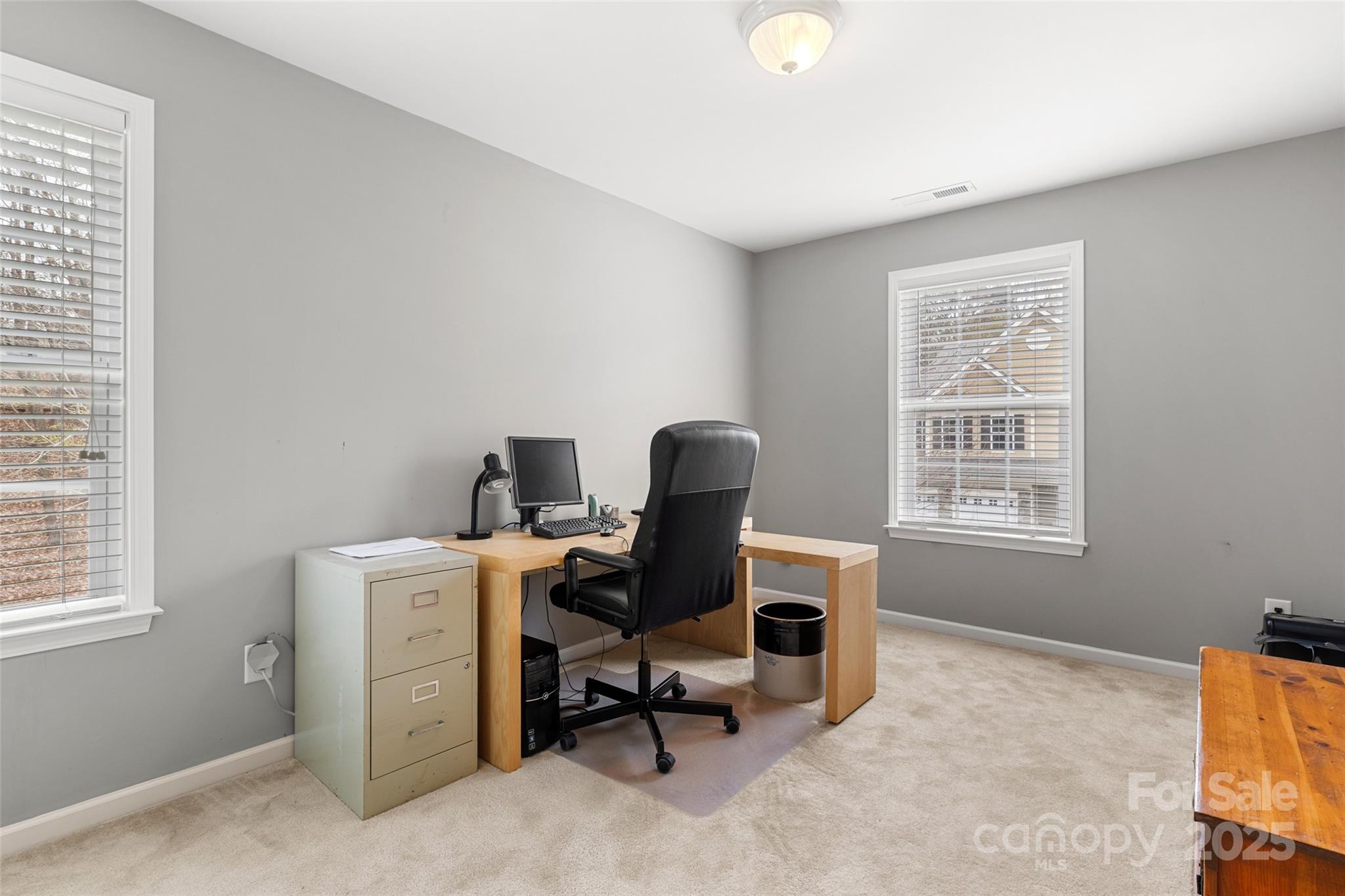 719 Deerbrook Lane Tega Cay, SC 29708 - Photo 19 of 33 a view of a workspace with furniture and a window