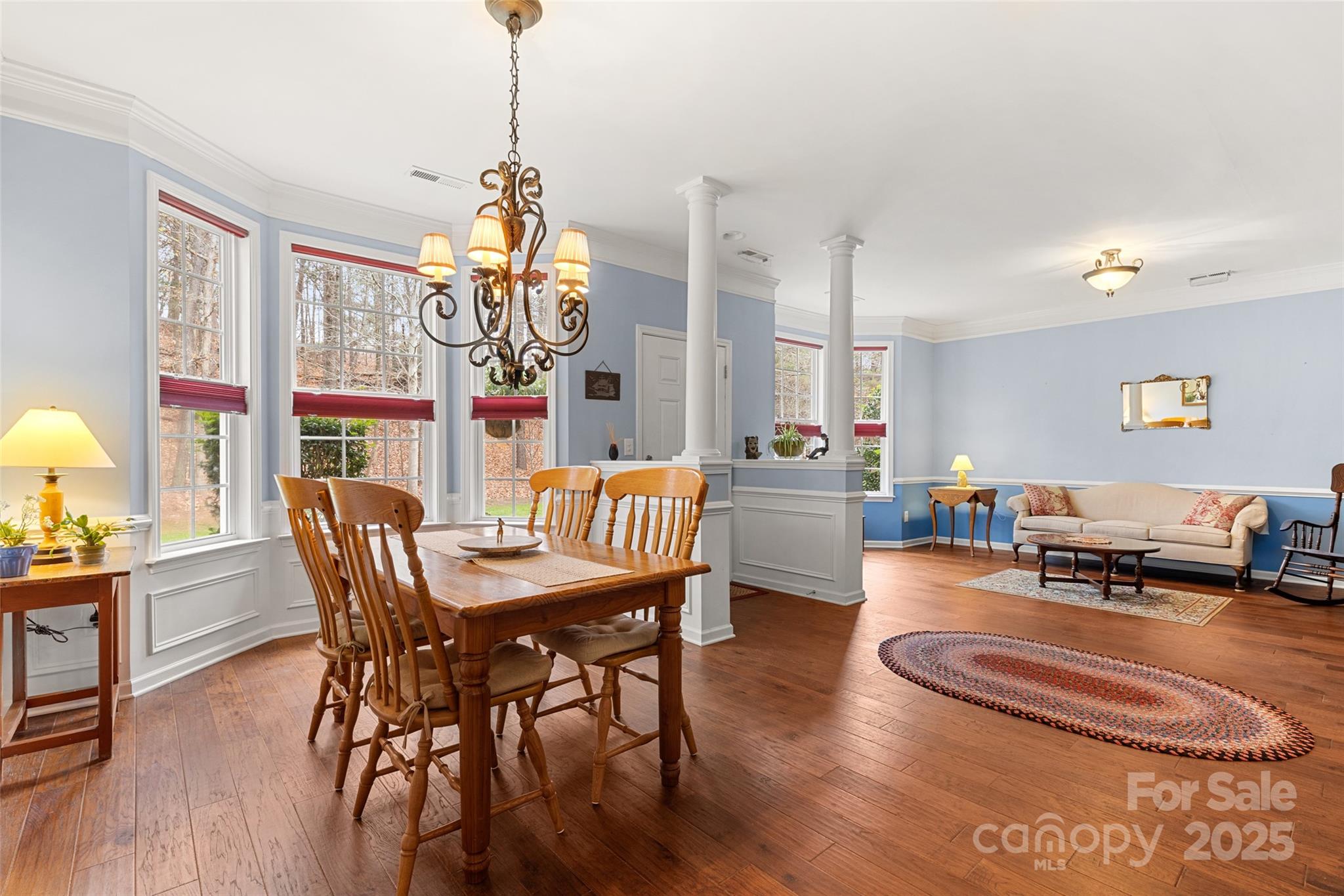 719 Deerbrook Lane Tega Cay, SC 29708 - Photo 3 of 33 a dining room with furniture a chandelier and wooden floor