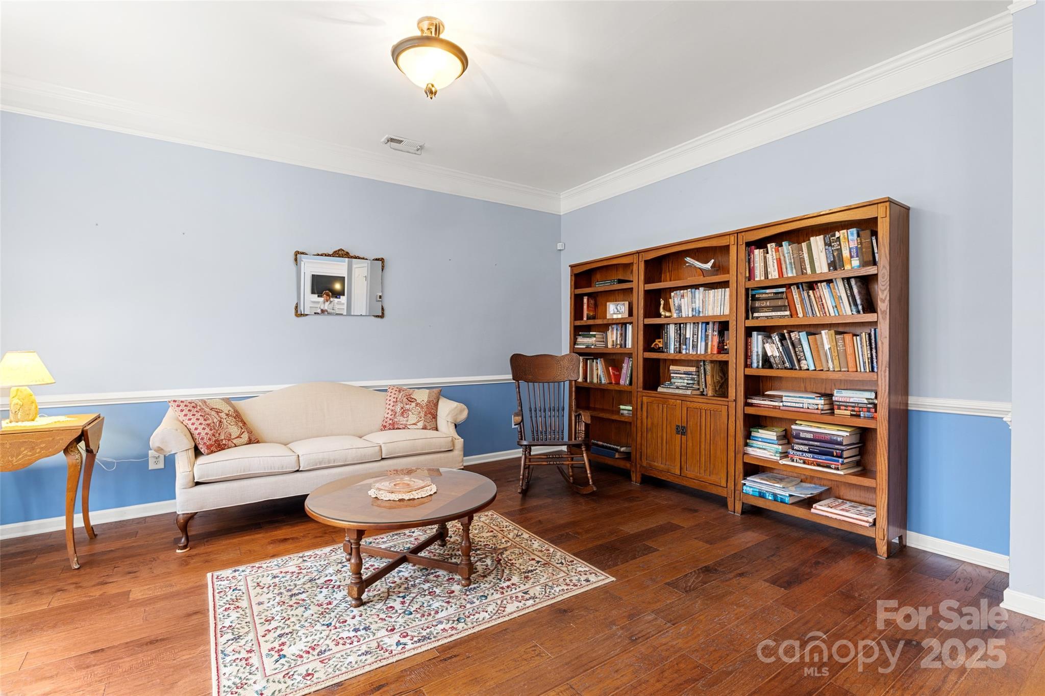 719 Deerbrook Lane Tega Cay, SC 29708 - Photo 5 of 33 a living room with furniture and a book shelf