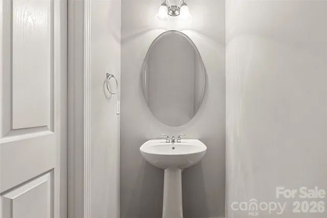 a bedroom with a large bed couch and windows