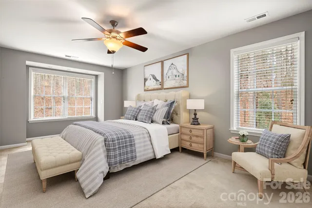 a bed room with a bed and a white wall painting