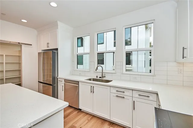a kitchen with a sink and refrigerator