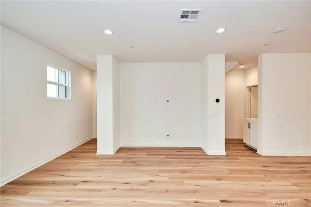 a view of a room with wooden floor and window
