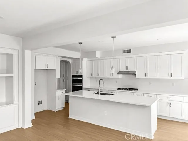 a kitchen with stainless steel appliances sink refrigerator and cabinets