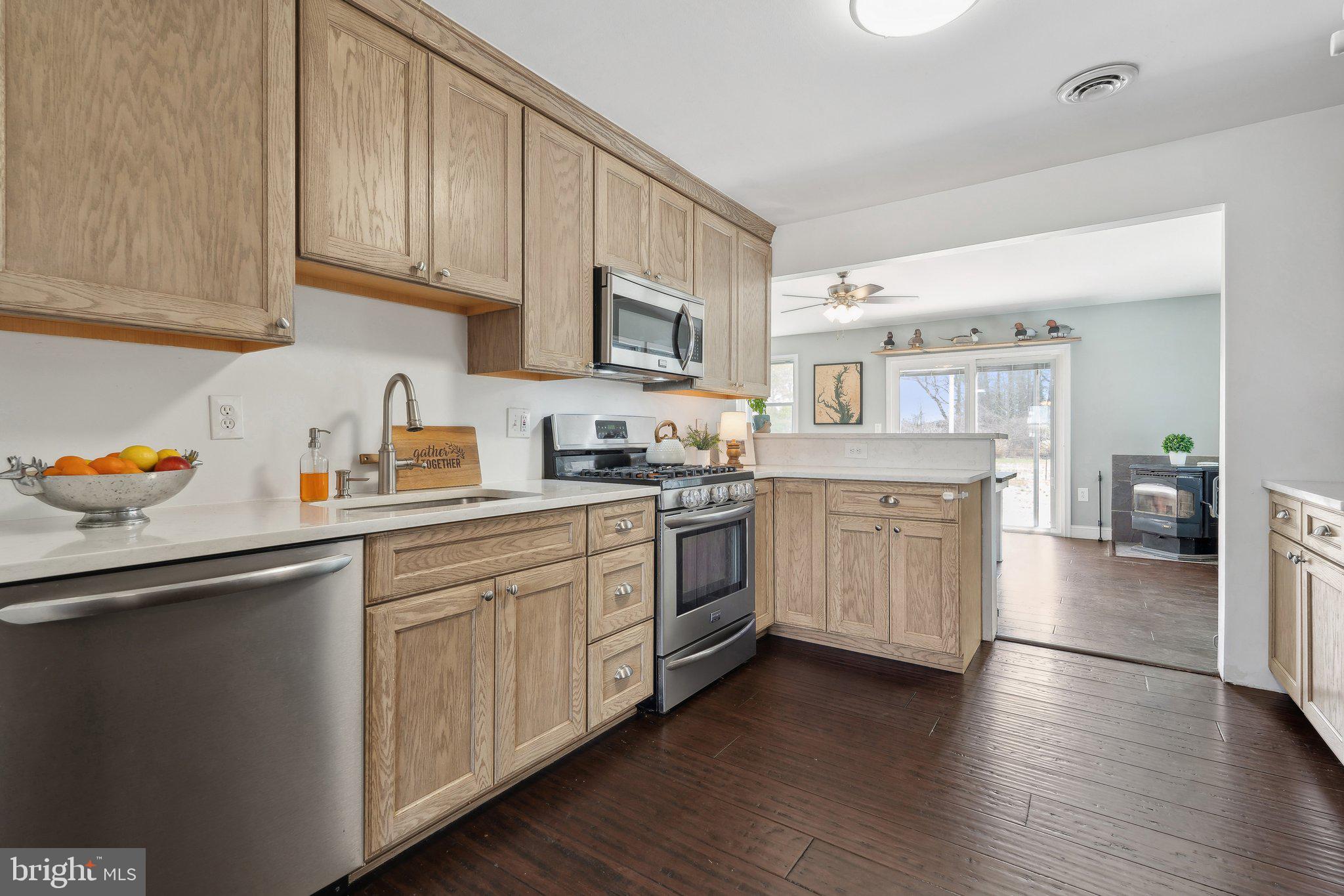 937 Winding Road Edgewater, MD 21037 - Photo 11 of 42 a kitchen with stainless steel appliances granite countertop a sink a stove and cabinets