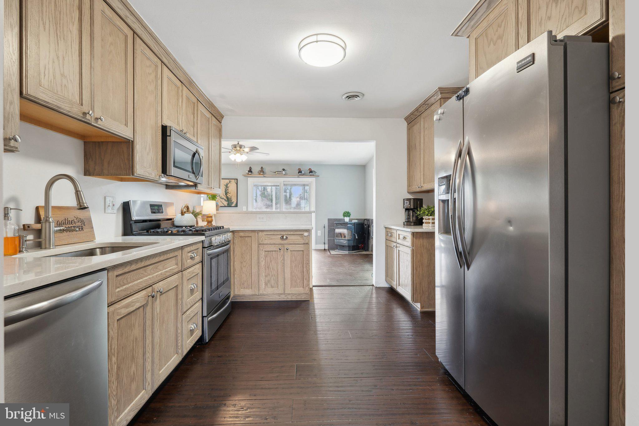 937 Winding Road Edgewater, MD 21037 - Photo 13 of 42 a kitchen with stainless steel appliances a refrigerator sink and cabinets