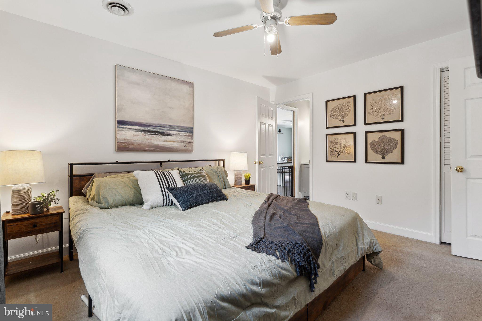 937 Winding Road Edgewater, MD 21037 - Photo 15 of 42 a bedroom with a large bed and a chandelier