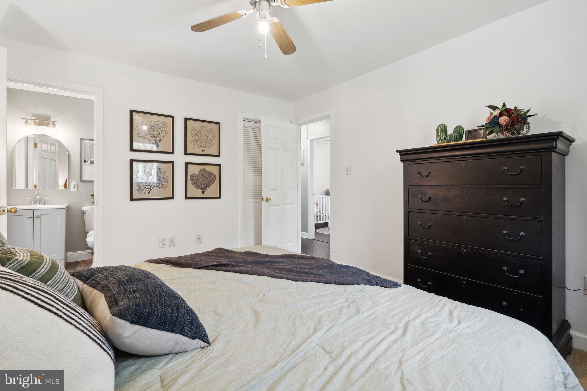 937 Winding Road Edgewater, MD 21037 - Photo 17 of 42 a bedroom with a bed and a chandelier