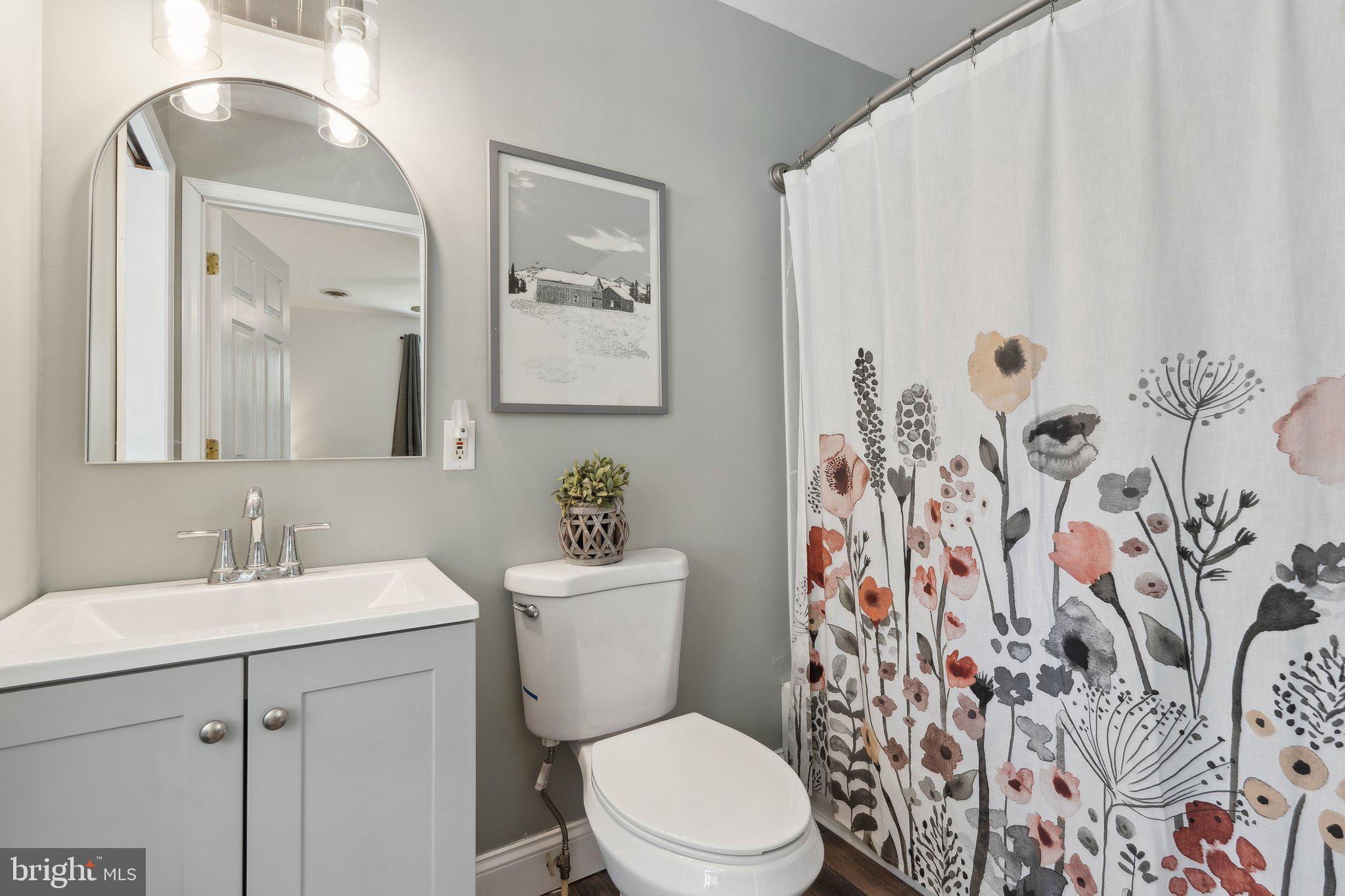 937 Winding Road Edgewater, MD 21037 - Photo 18 of 42 a bathroom with a toilet sink and mirror