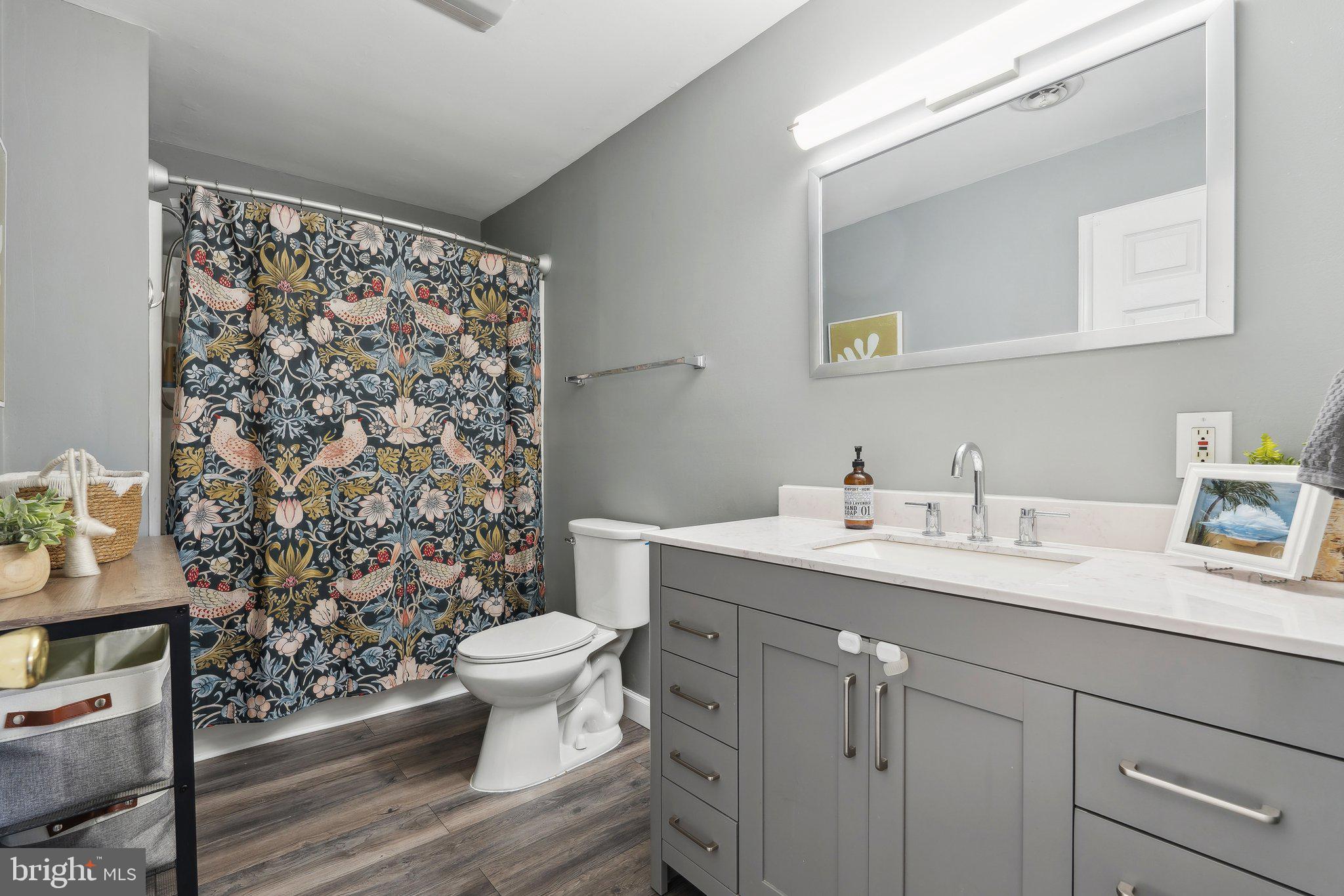 937 Winding Road Edgewater, MD 21037 - Photo 24 of 42 a bathroom with a granite countertop sink toilet and mirror