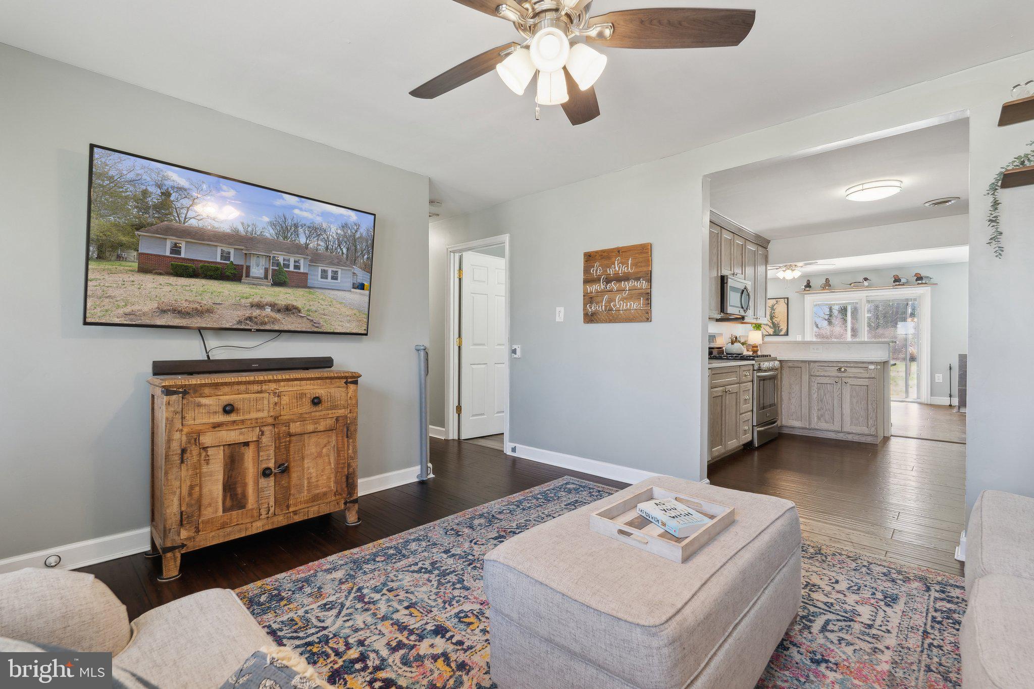 937 Winding Road Edgewater, MD 21037 - Photo 4 of 42 a living room with furniture and paintings on the wall