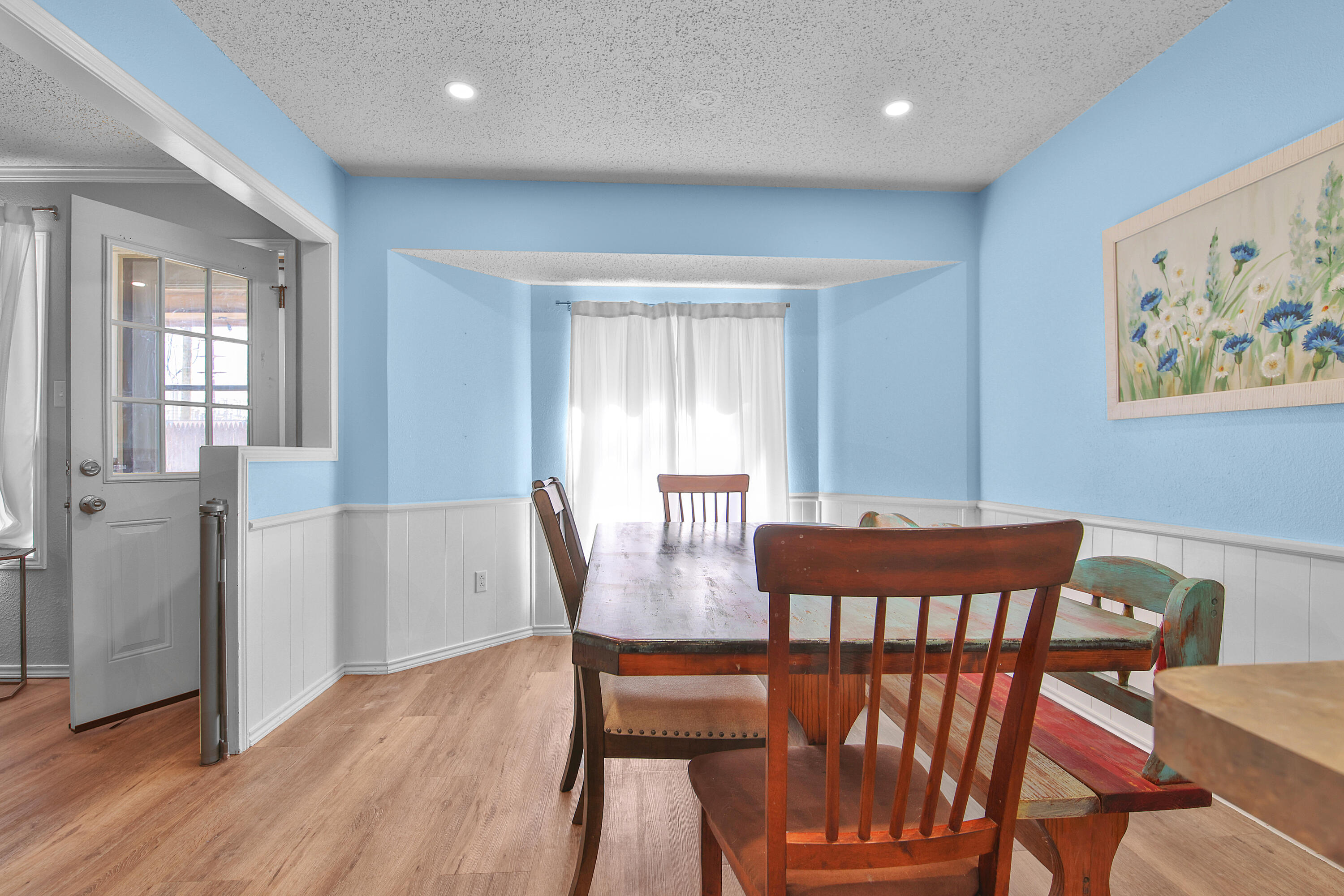4805 73rd Street Lubbock, TX 79424 - Photo 12 of 26 a view of a dining room with furniture window and wooden floor