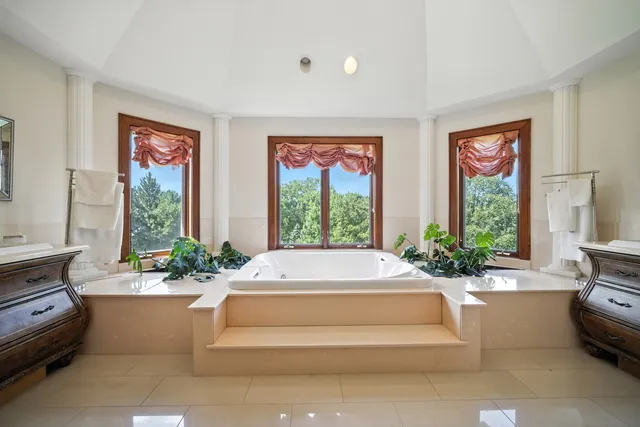 a living room with furniture and large windows