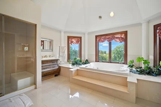 a spacious bedroom with a bed and a large window