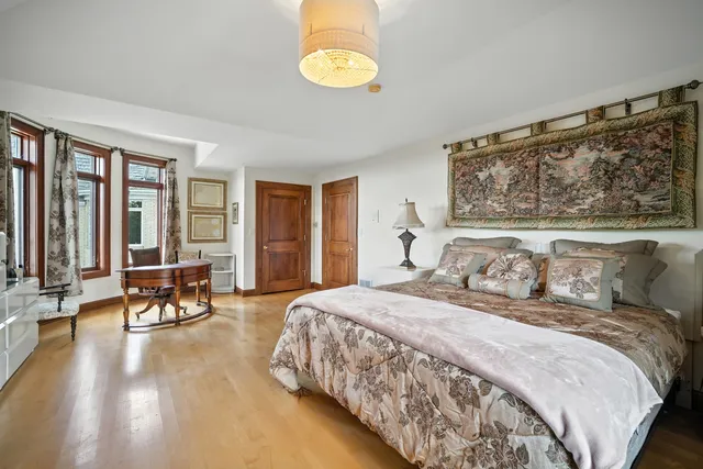 a bedroom with a bed and a large window