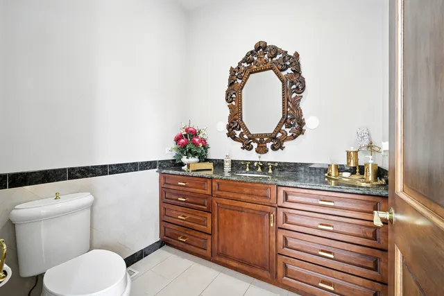 a bathroom with a toilet a sink and a mirror