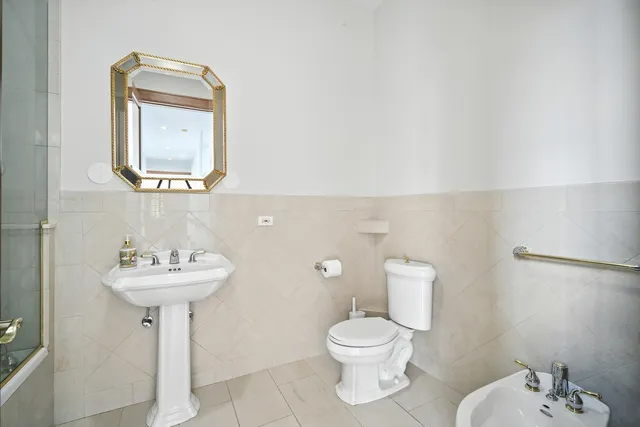 a bathroom with a sink a mirror and a toilet