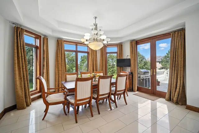 a view of a dining room with furniture large windows and wooden floor
