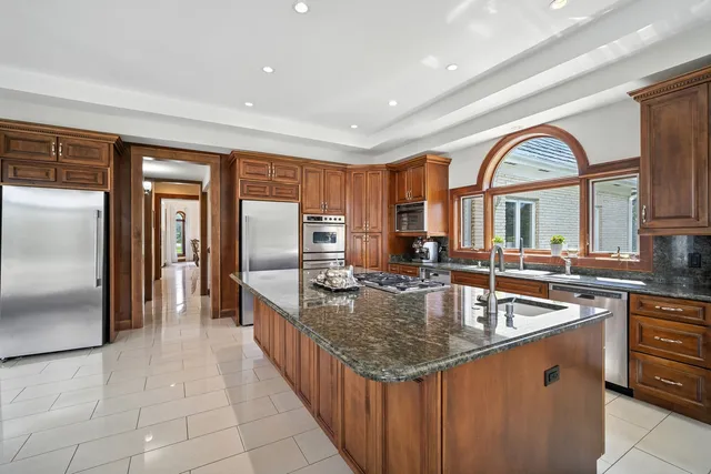 a kitchen with stainless steel appliances granite countertop a sink a counter space and stainless steel appliances