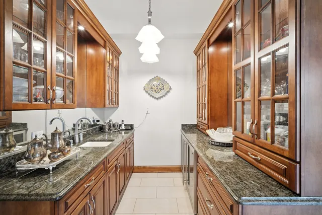 a bathroom with a granite countertop sink a vanity and a mirror