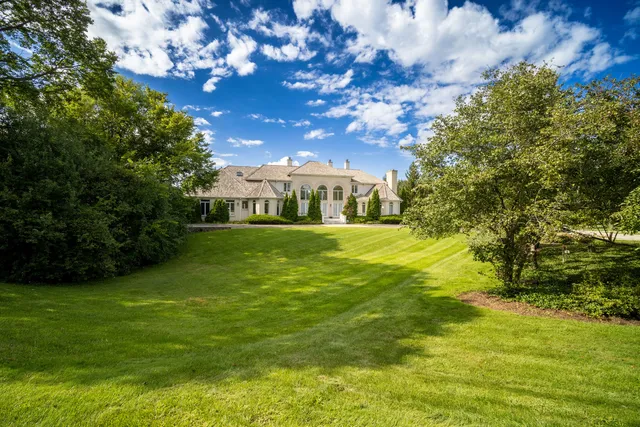 a view of yard with swimming pool and green space