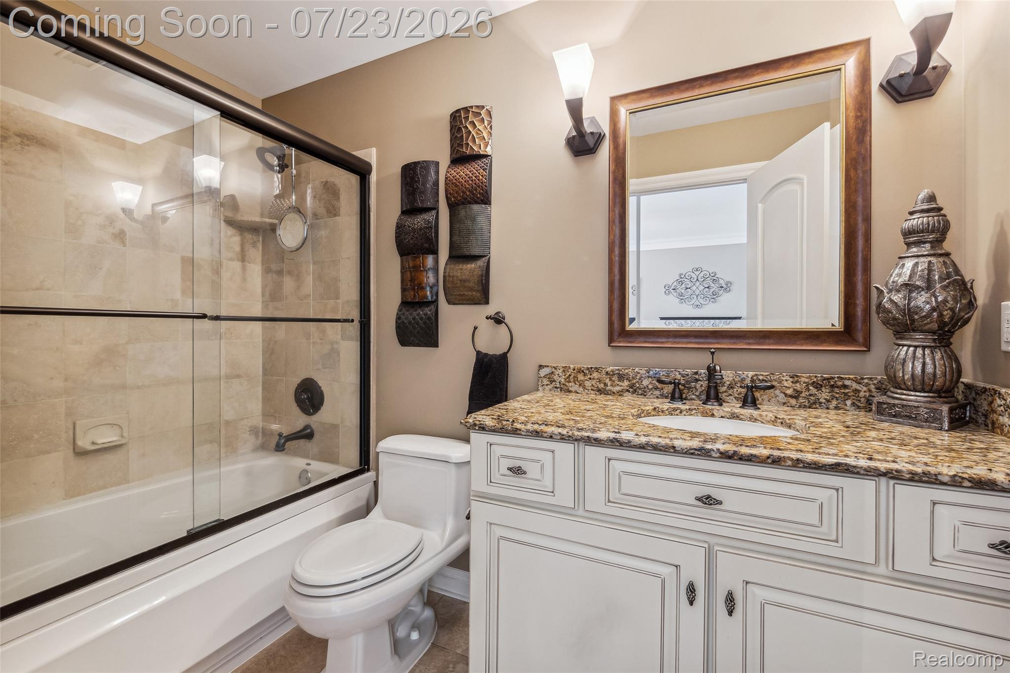 5460 Cochrane Road Almont, MI 48003 - Photo 27 of 48 Bathroom featuring a granite-finish vanity, decorative framed mirror, and dual wall sconces