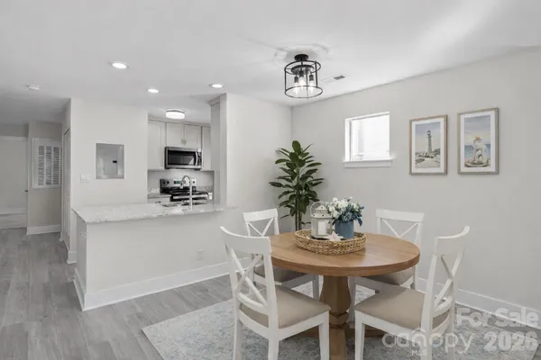 a view of open kitchen with wooden floor and window