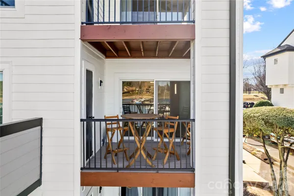 a view of a balcony with furniture and city view