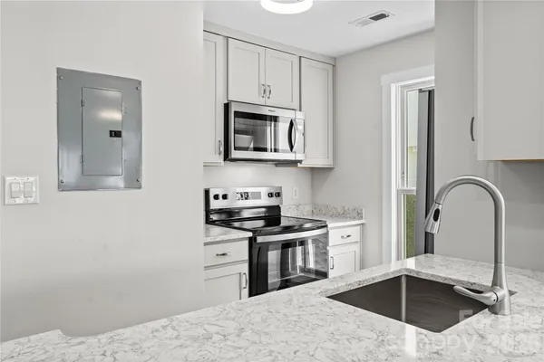 a kitchen with a stove and a microwave