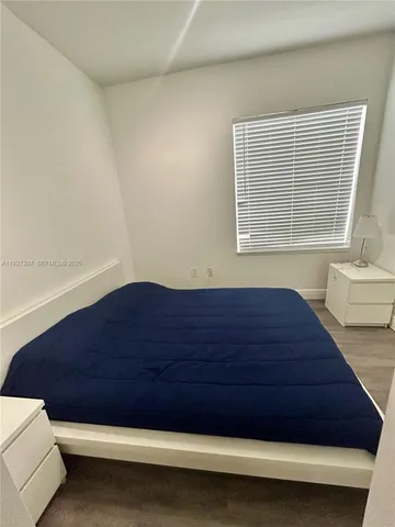 a view of wooden floor and windows in a room