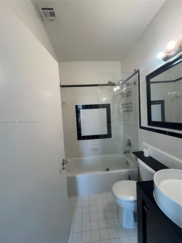 a bathroom with a toilet a sink and bathtub