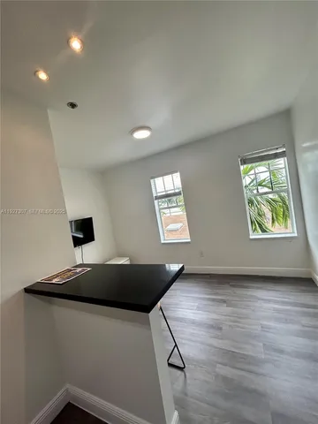 a view of room with window and wooden floor